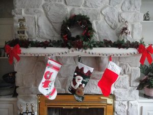 Christmas stockings are hung by the fireplace